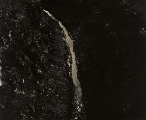 A waterfall is shown in the dark.