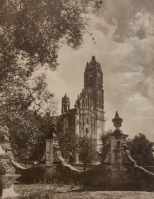 A large cathedral with a clock tower in the background.