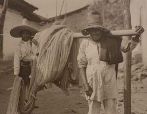 Two people in hats and a horse.