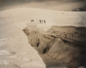 A group of people standing on top of a snow covered slope.