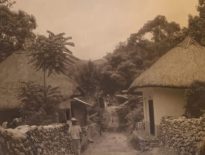 A black and white photo of people walking in the street.