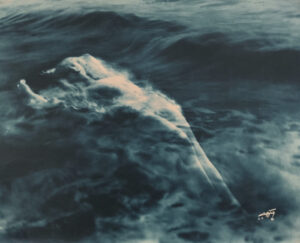 A large body of water with clouds and waves
