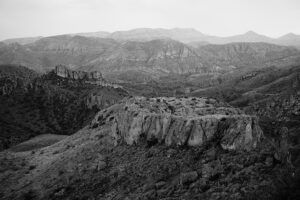 A black and white photo of mountains in the distance.