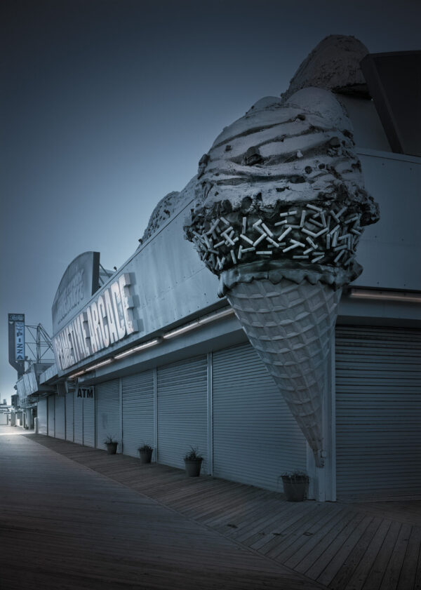 A large ice cream cone on the side of a building.