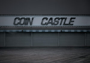 A sign that says coin castle on the side of a building.
