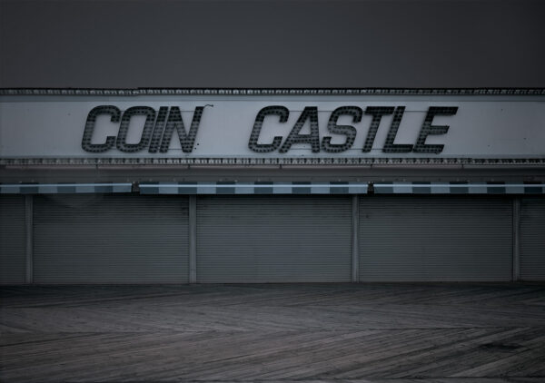 A sign that says coin castle on the side of a building.