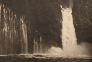 A black and white photo of a waterfall