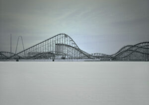 A roller coaster is shown in the snow.