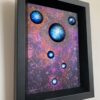 A painting of blue planets in the sky.