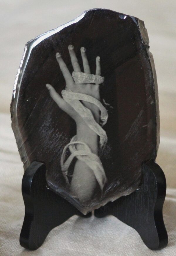 A skeleton hand is shown in the middle of a coffin.