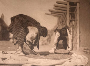 A man is working on something in the dirt.