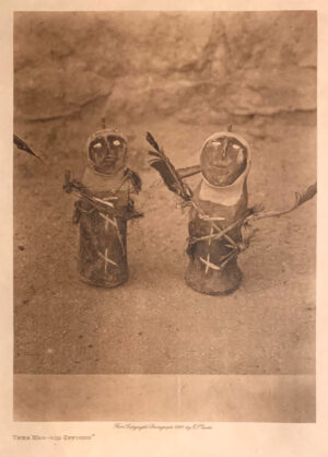 Two people are holding hands in a sepia photo.