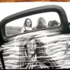 A black and white photo of two girls in the back seat of a car.