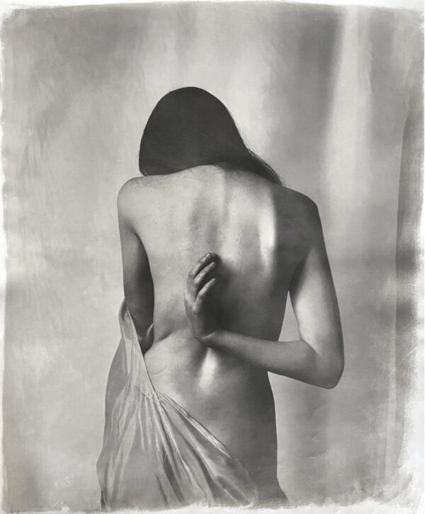 A woman with her back turned to the camera.