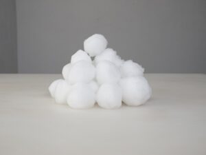A pile of white cotton balls on top of a table.