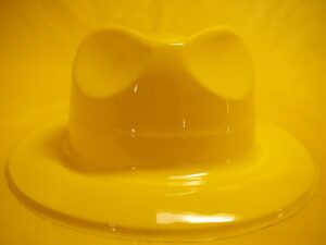 A yellow bowl with a bow on top of it.
