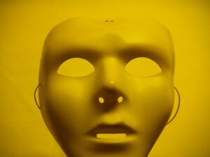 A yellow mask is shown with the nose slightly raised.