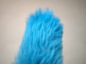 A blue furry object is shown in this picture.