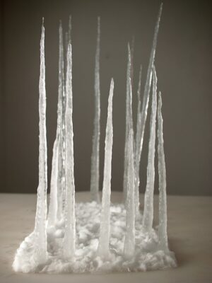 A group of icicles are shown in the snow.