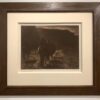 A framed photograph of two horses walking in the field.