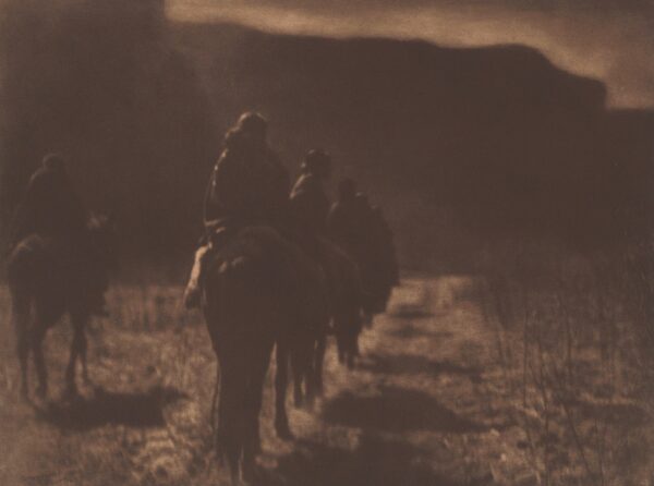 A group of people riding on the back of horses.