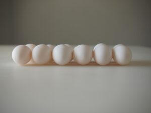 A row of white eggs sitting on top of a table.