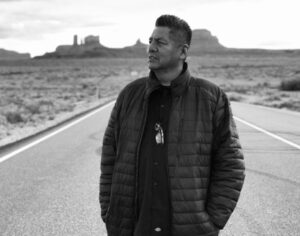 A man standing on the side of a road.