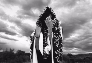 A person with a black and white scarf on