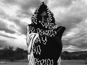 A person with a blanket wrapped around their head