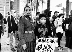 A woman and child holding up a sign.
