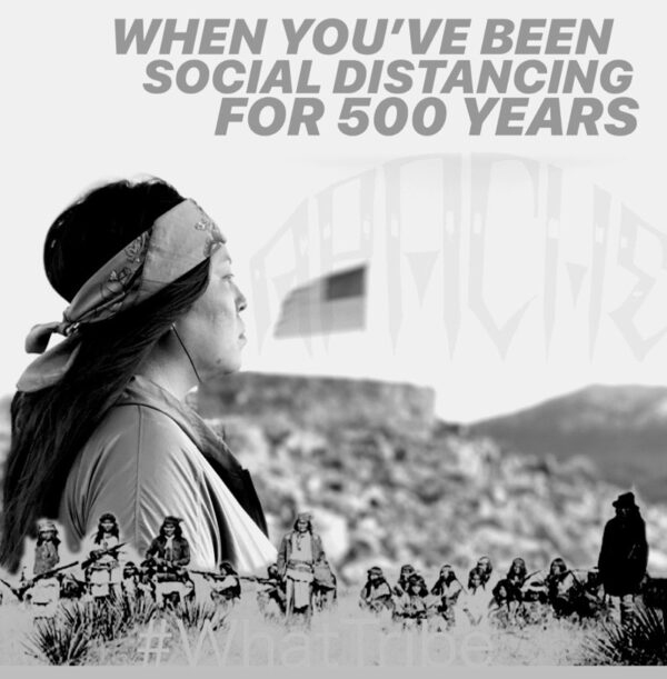 A woman in a field with a bandana on her head.