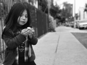 A young girl is looking at her cell phone.