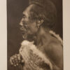 A man with white fur on his shoulders and face.