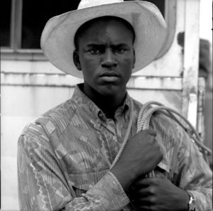 A man in a cowboy hat and shirt.