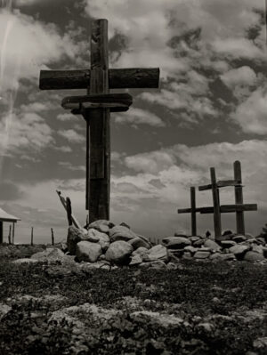 A black and white photo of three crosses