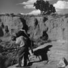 A man standing on top of a rock formation.