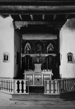 A church with a large altar and two paintings.