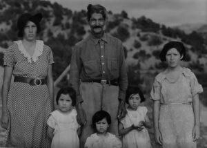 A black and white photo of a family.