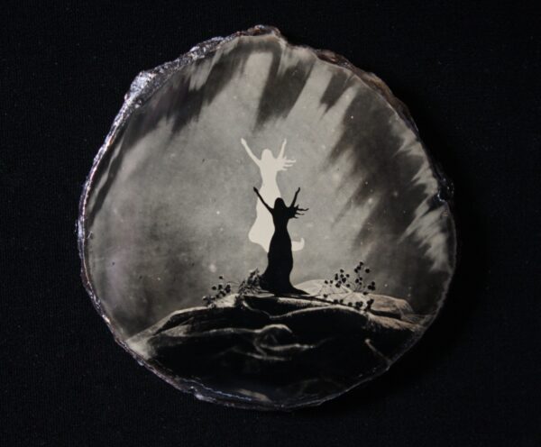 A painting of a person standing on top of a rock.