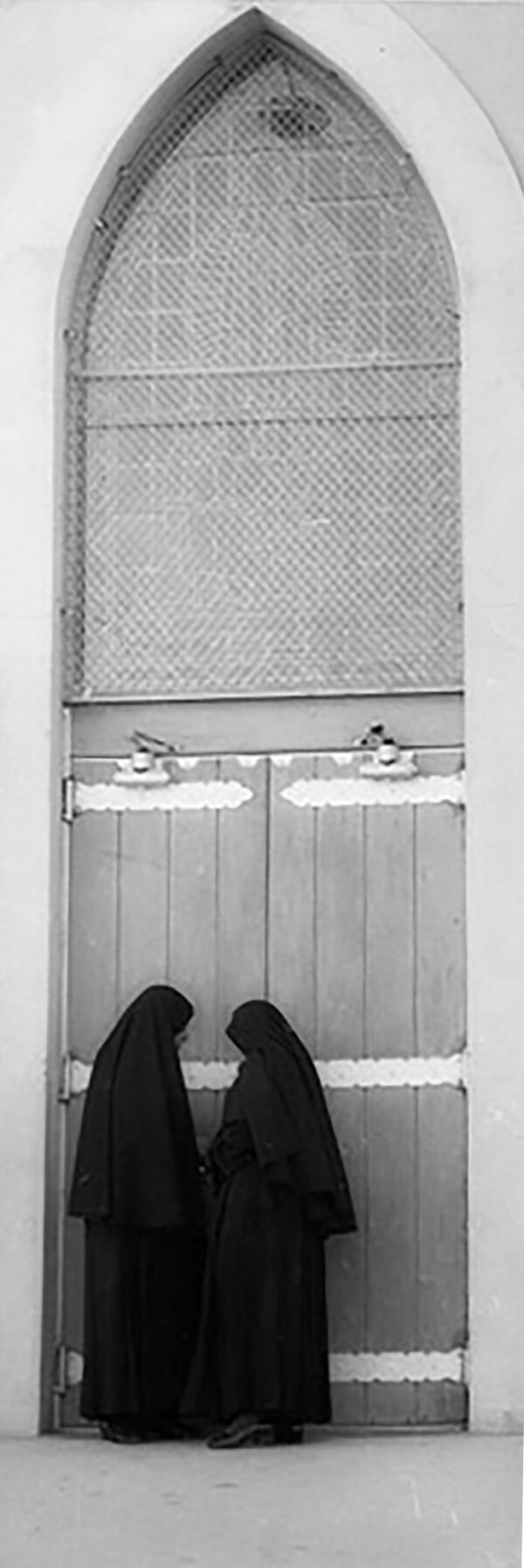 A pair of feet standing in front of a door.