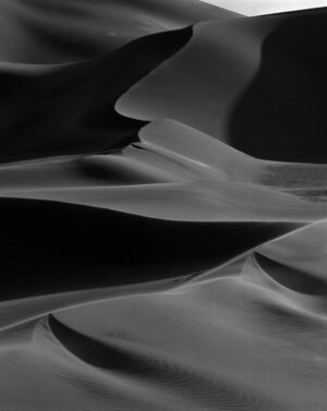 A black and white photo of some sand dunes