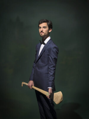 A man in a suit holding an axe