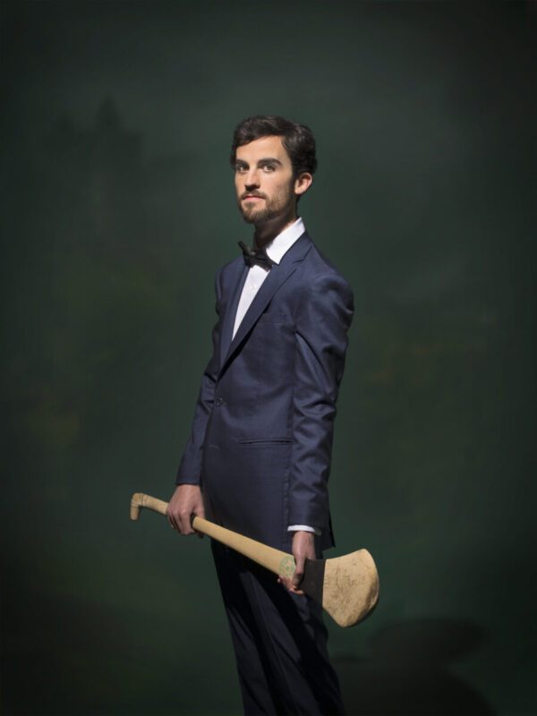 A man in a suit holding an axe