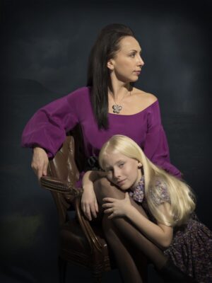 A woman and girl sitting on a chair