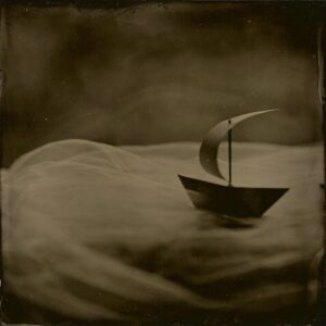 A small boat floating on top of water.