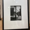 A black and white photo of a woman sitting on the stairs.