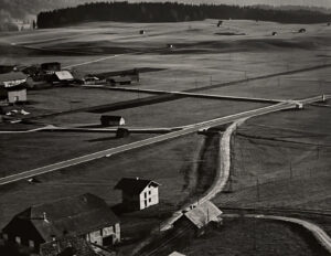An aerial view of a farm with buildings and roads.