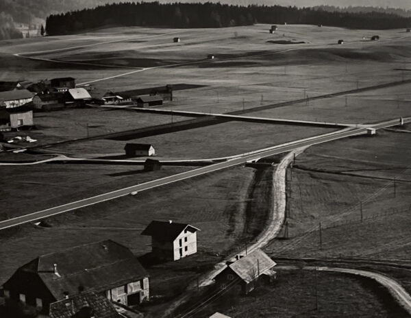 An aerial view of a farm with buildings and roads.