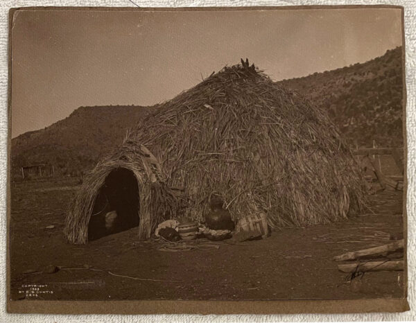 A hut made of straw and grass in the desert.