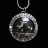 A necklace with a picture of the moon and stars.